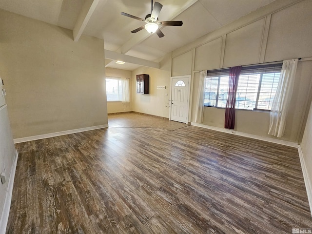 interior space with ceiling fan, dark hardwood / wood-style flooring, and beam ceiling