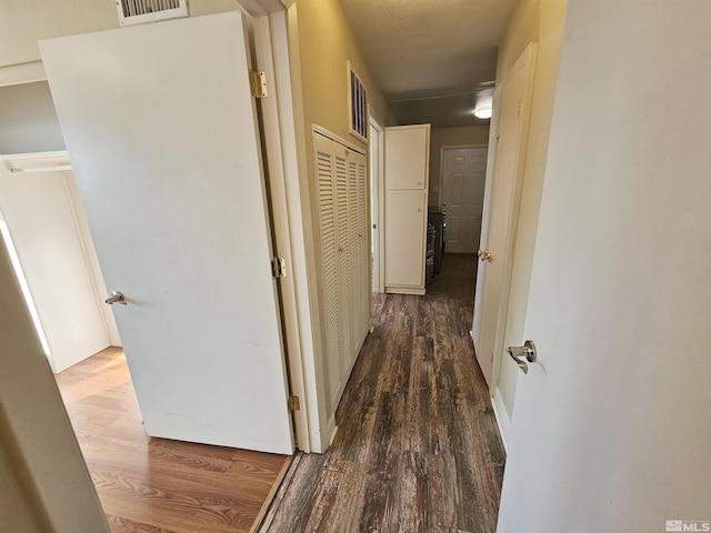 hallway featuring dark hardwood / wood-style flooring