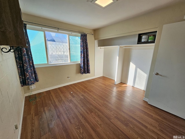 unfurnished bedroom with a closet and hardwood / wood-style floors