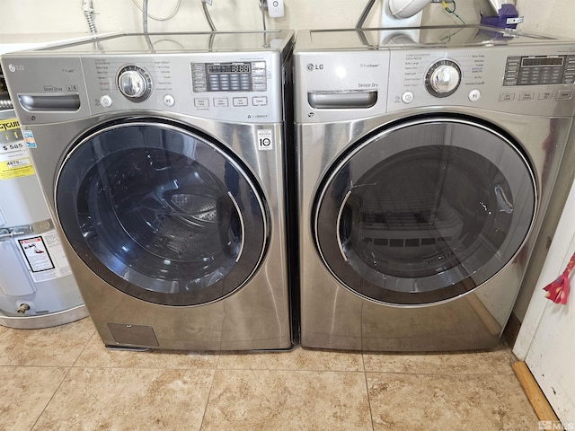 laundry room with washer and dryer and light tile patterned floors