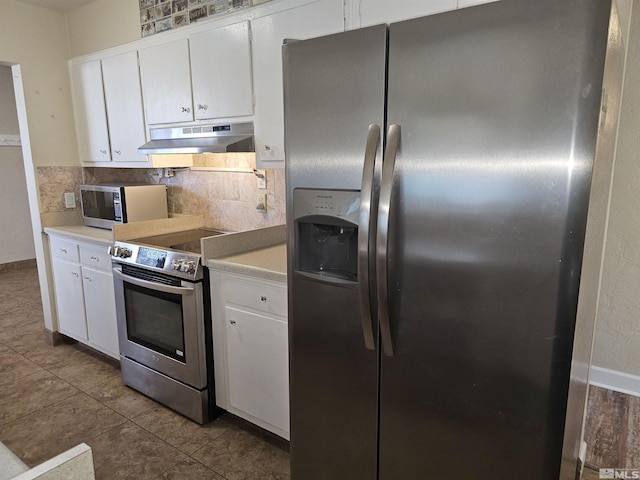 kitchen with stainless steel appliances, light tile patterned floors, white cabinets, and tasteful backsplash