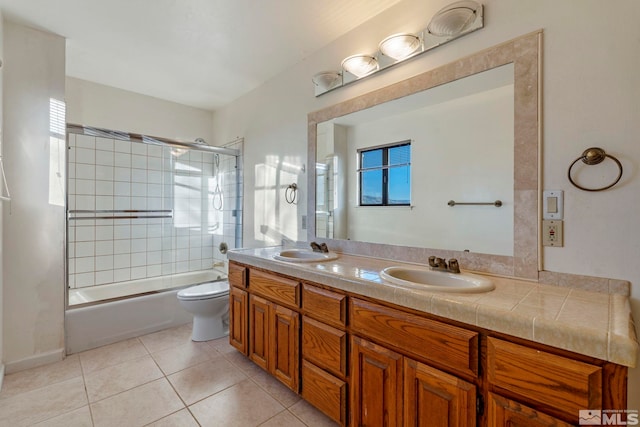 full bathroom with shower / bath combination with glass door, toilet, tile patterned floors, and vanity