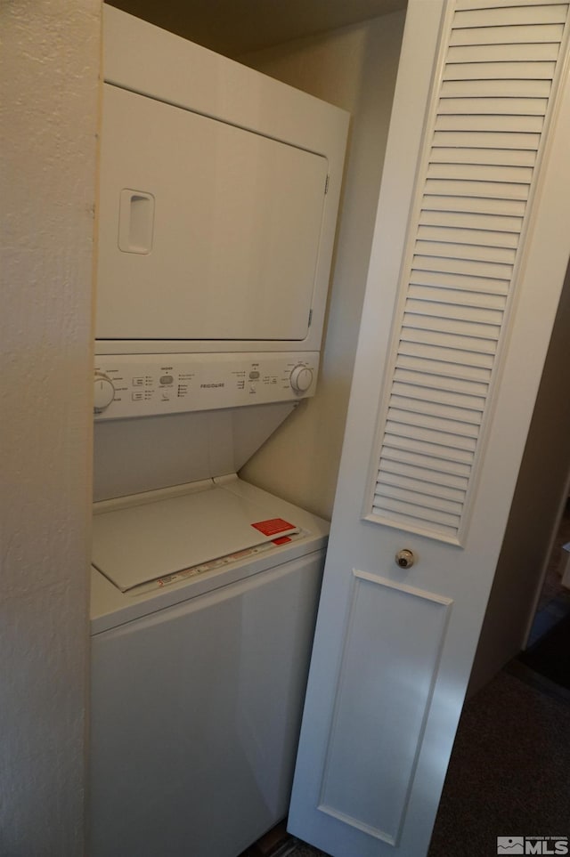 laundry room featuring stacked washer / dryer