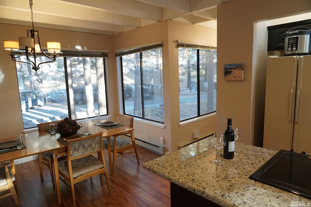 interior space featuring baseboard heating and a chandelier