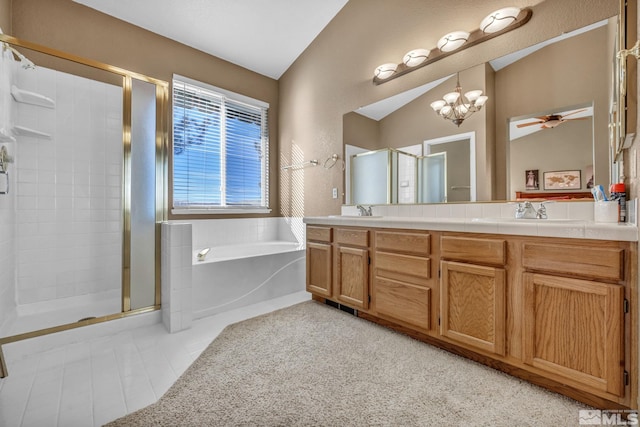 bathroom featuring ceiling fan with notable chandelier, lofted ceiling, plus walk in shower, and vanity