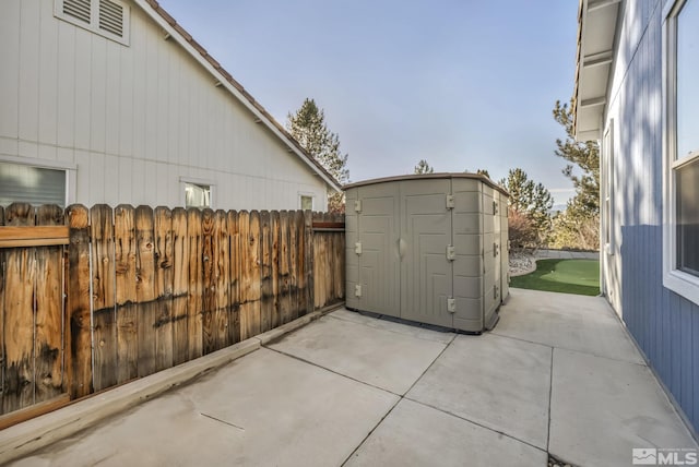 view of patio / terrace featuring a storage unit