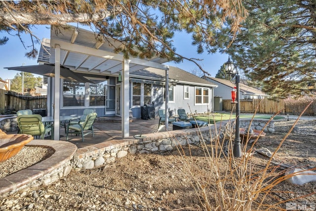 rear view of property featuring a patio area and a pergola