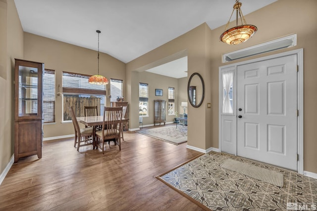 entrance foyer with hardwood / wood-style floors and lofted ceiling