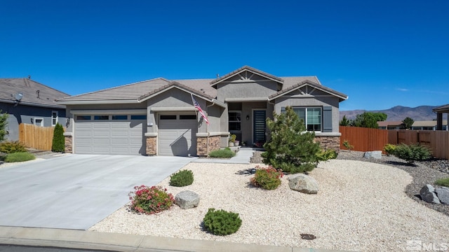 view of front of house with a garage and a mountain view