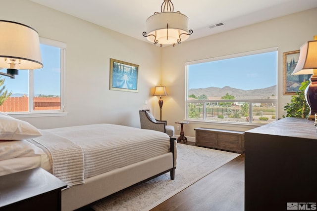 bedroom featuring a mountain view and hardwood / wood-style floors