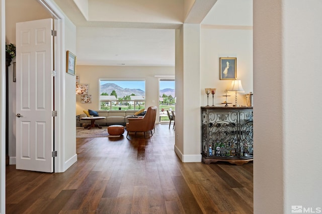 hall with dark wood-type flooring and a mountain view