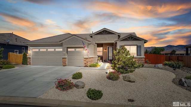 view of front of house with a garage and a mountain view