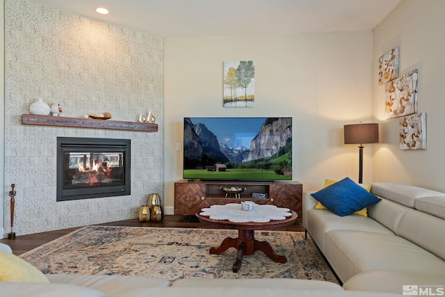 living room featuring wood-type flooring and a fireplace