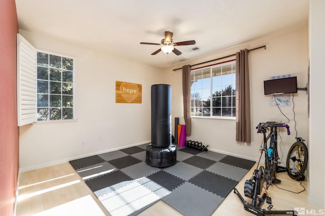 workout room featuring dark wood-type flooring and ceiling fan