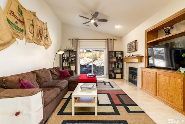 living room with lofted ceiling, a fireplace, light wood-type flooring, and ceiling fan