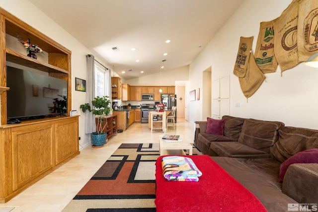 living room with vaulted ceiling and light hardwood / wood-style flooring