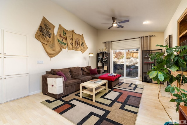 living room featuring lofted ceiling, ceiling fan, and light hardwood / wood-style flooring