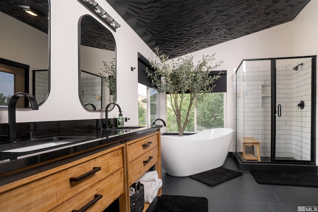 bathroom featuring shower with separate bathtub, tile patterned floors, and vanity