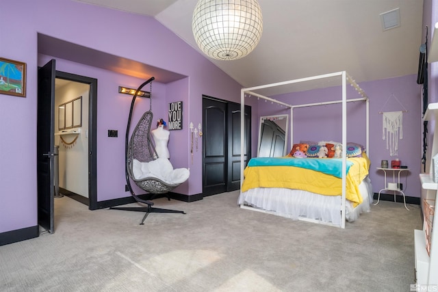 bedroom with a closet, vaulted ceiling, and light colored carpet