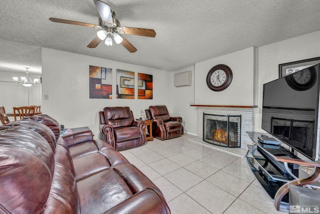 tiled living room featuring a textured ceiling and ceiling fan with notable chandelier