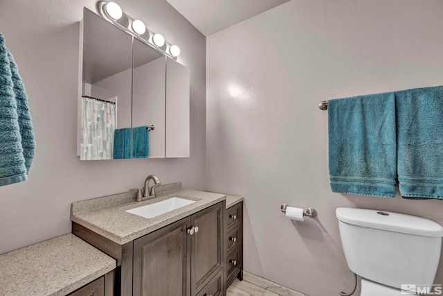 bathroom with toilet and vanity