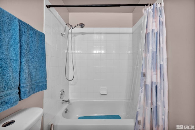 bathroom featuring toilet and shower / bath combo with shower curtain