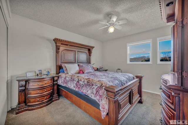 carpeted bedroom with a textured ceiling and ceiling fan