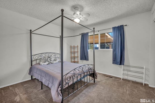 carpeted bedroom featuring ceiling fan and a textured ceiling