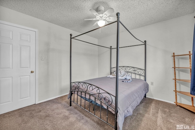 carpeted bedroom with ceiling fan and a textured ceiling