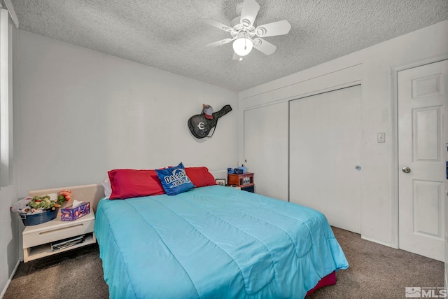 carpeted bedroom featuring a closet, ceiling fan, and a textured ceiling