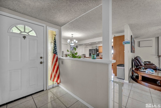 entryway featuring an inviting chandelier and light tile patterned flooring