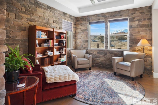 living area with a mountain view and wood-type flooring