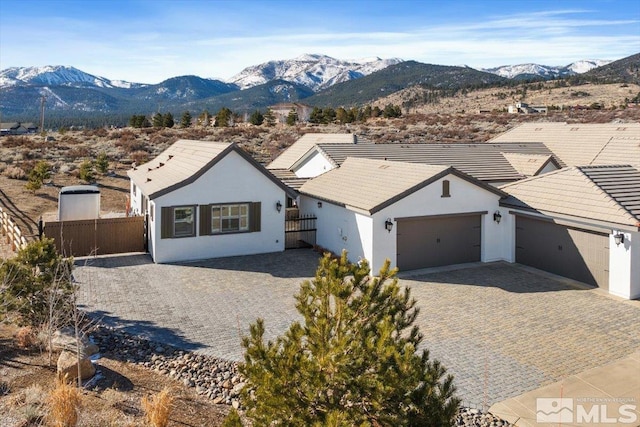 single story home featuring a garage and a mountain view