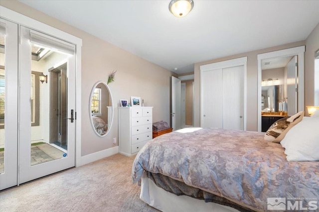 carpeted bedroom featuring ensuite bath