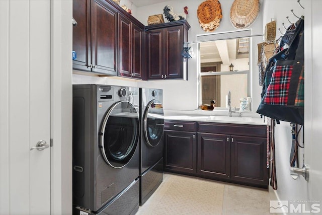 clothes washing area featuring sink, light tile patterned floors, cabinets, and independent washer and dryer