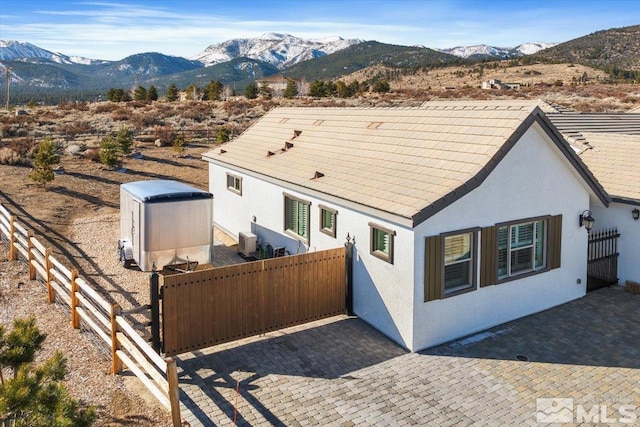 rear view of house with a patio and a mountain view