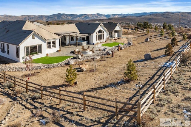 back of house with a patio area, a pergola, and a mountain view