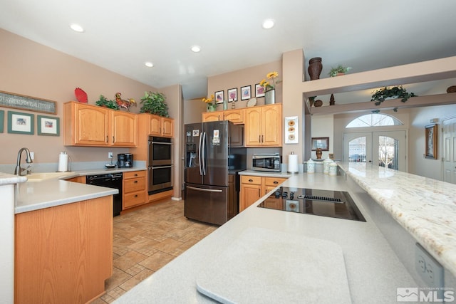 kitchen with sink, french doors, black appliances, and kitchen peninsula