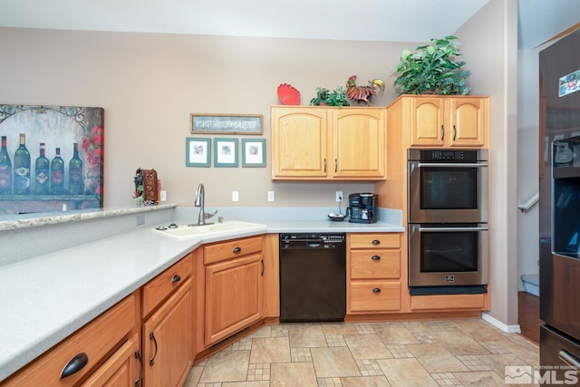 kitchen featuring sink, dishwasher, light brown cabinetry, and stainless steel double oven