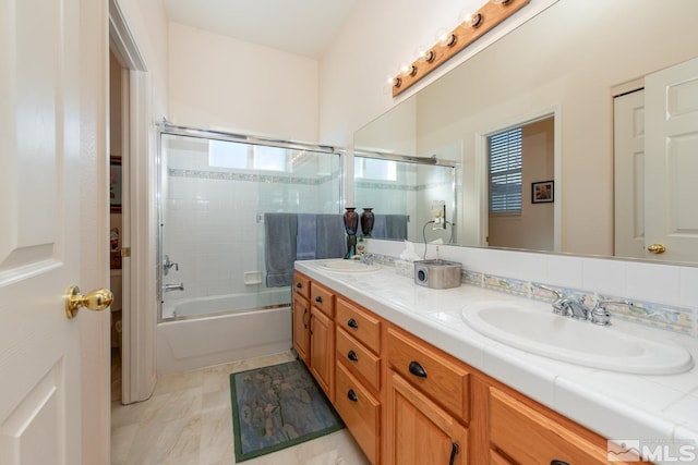 bathroom featuring vanity and enclosed tub / shower combo