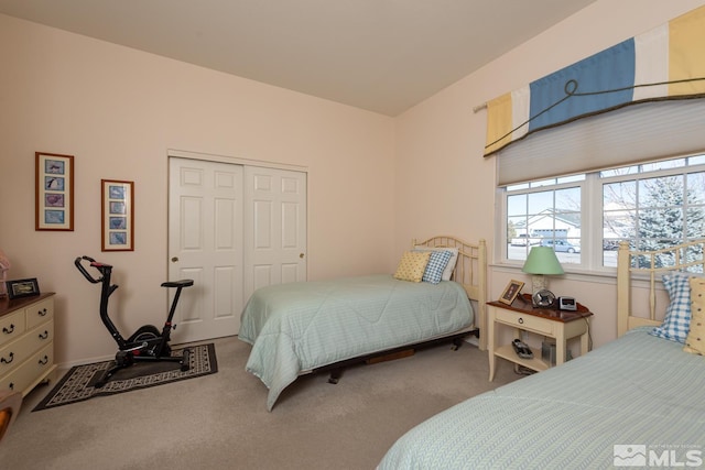 carpeted bedroom with a closet