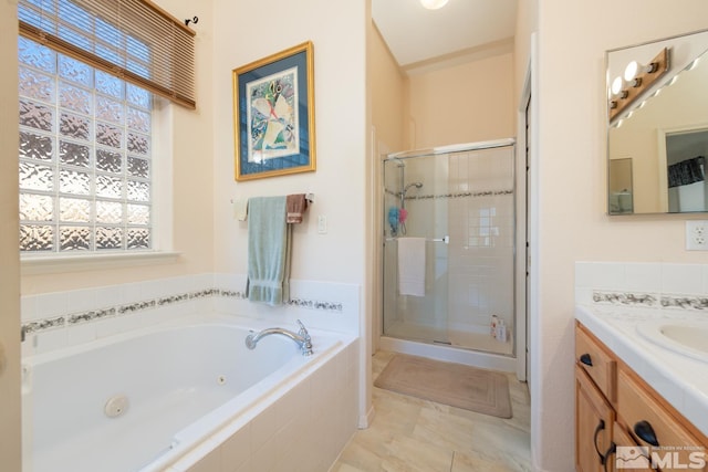 bathroom featuring vanity and separate shower and tub