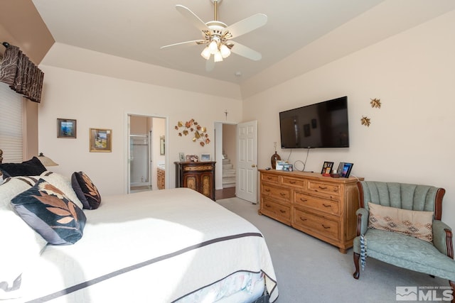 bedroom featuring light carpet, connected bathroom, and ceiling fan