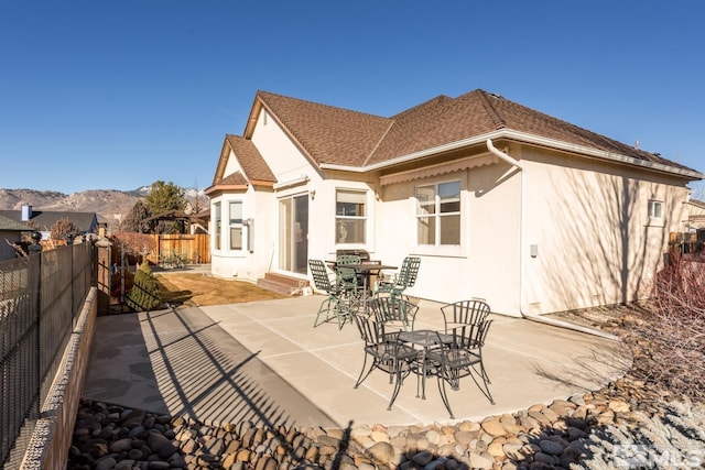 back of property featuring a patio and a mountain view