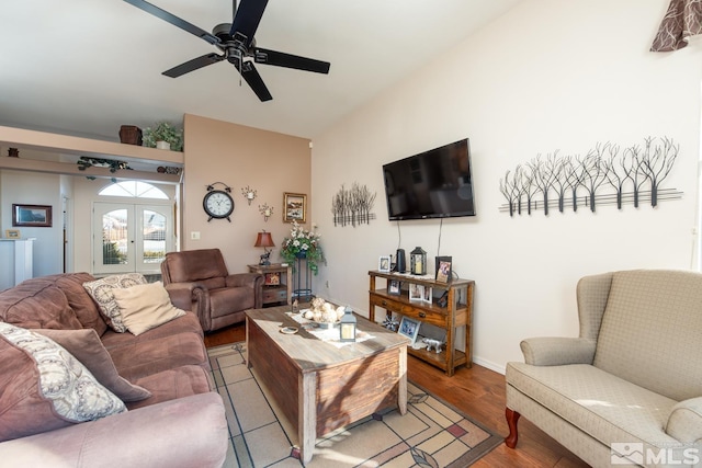 living room featuring light hardwood / wood-style floors, ceiling fan, french doors, and lofted ceiling