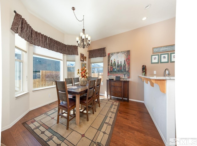 dining area with a chandelier and dark hardwood / wood-style floors