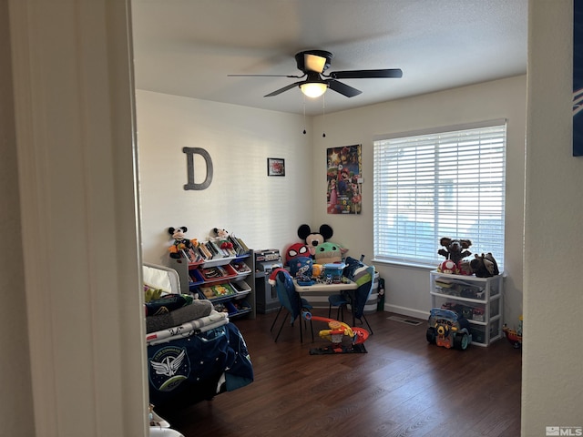 game room with ceiling fan and dark hardwood / wood-style floors