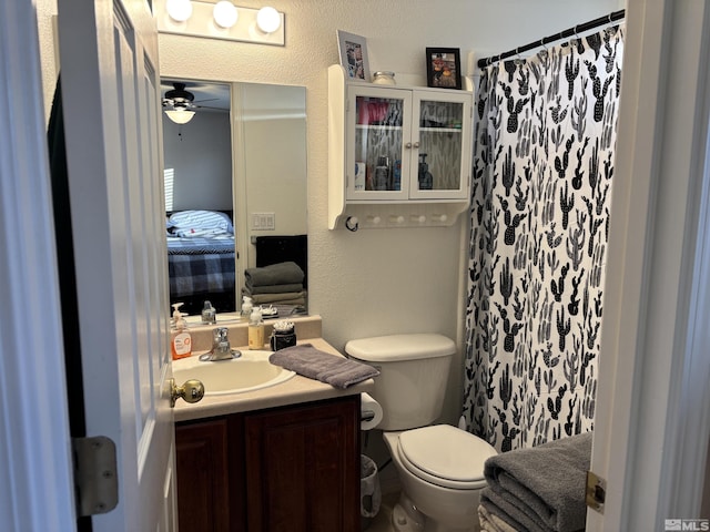 bathroom featuring ceiling fan, vanity, and toilet