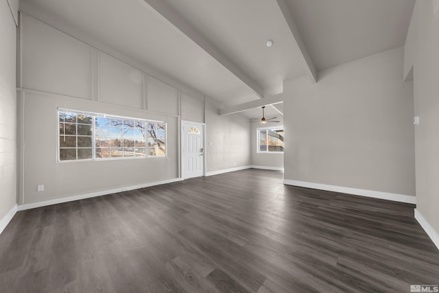 unfurnished living room with ceiling fan, dark hardwood / wood-style floors, and vaulted ceiling with beams