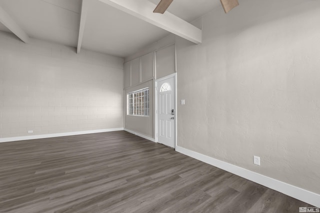 foyer entrance with dark wood-type flooring and beamed ceiling